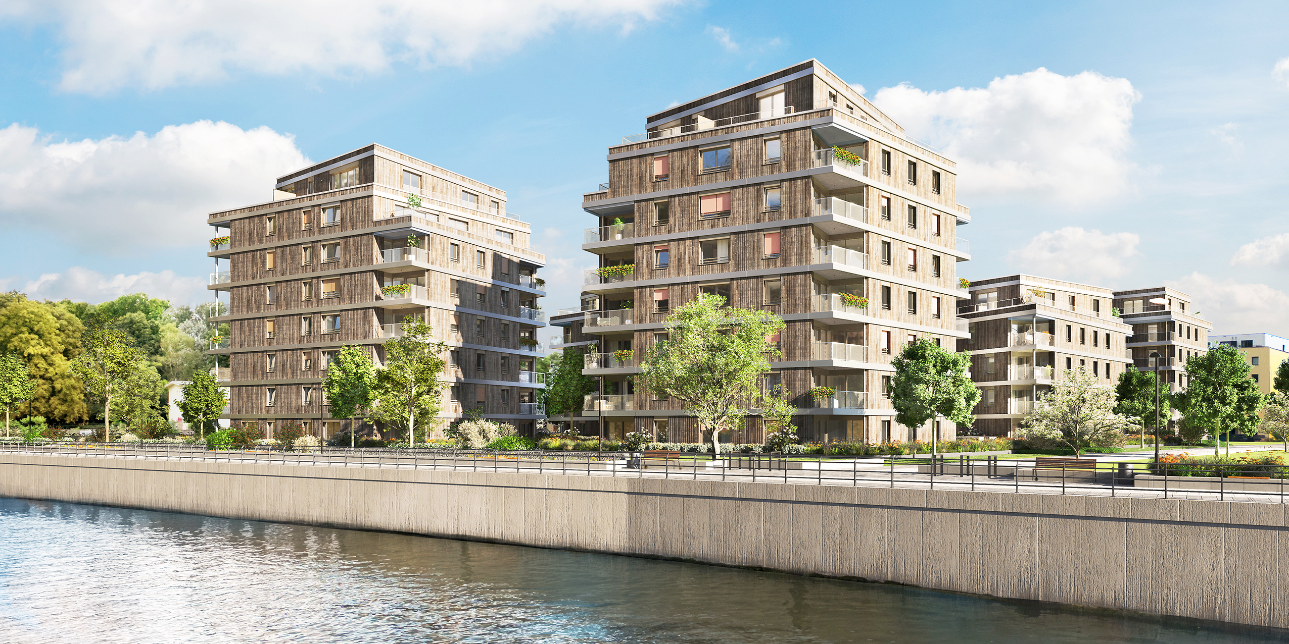 The BUWOG Weydenhof project can be seen, in front the water, then the promenade, followed by 2 houses of the project, behind it a house is clearly visible and behind it the last house can be seen a little.