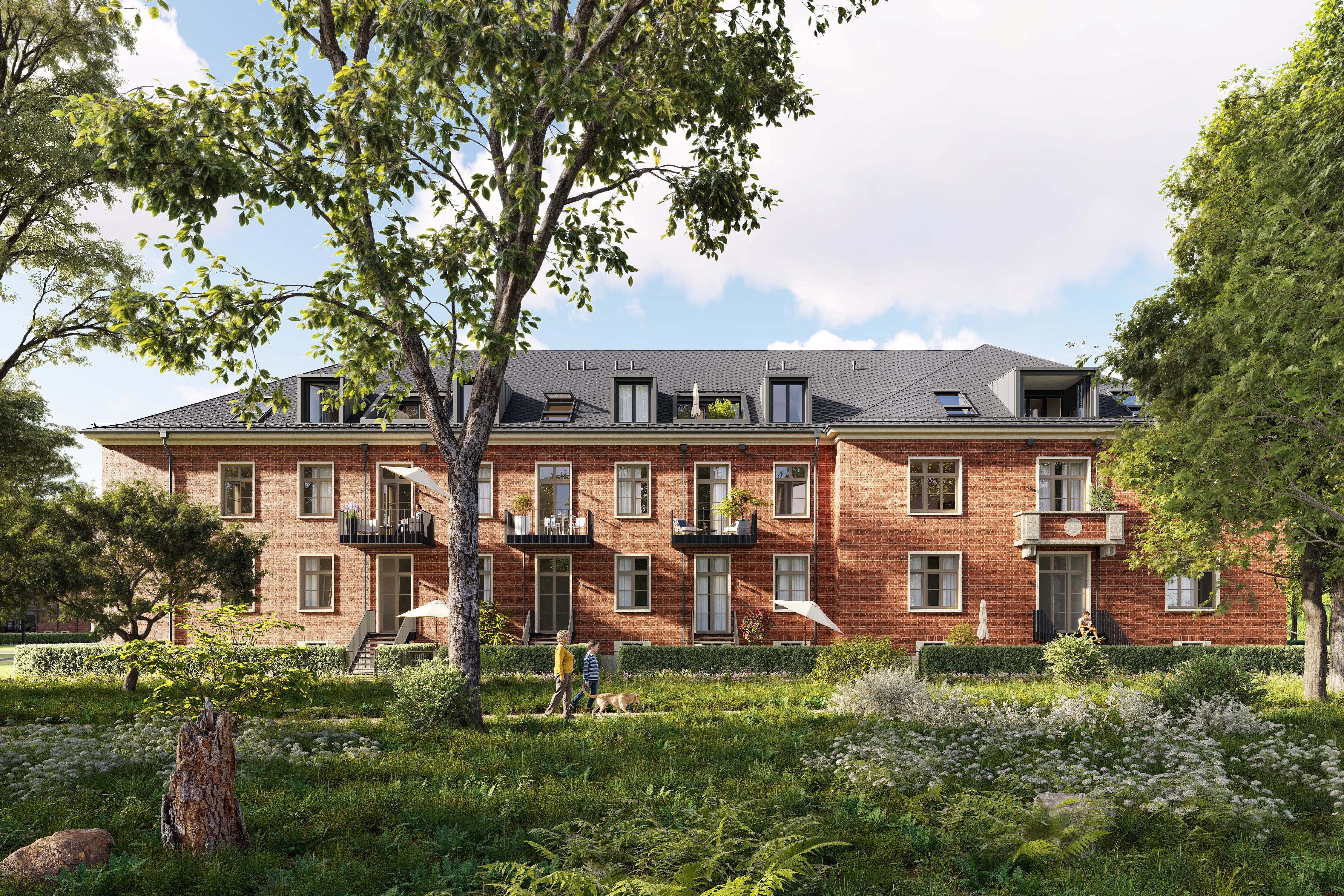 Zu sehen ist frontal ein braunes Haus des Projekts BUWOG Lillestad mit Grünanlagen und Personen.