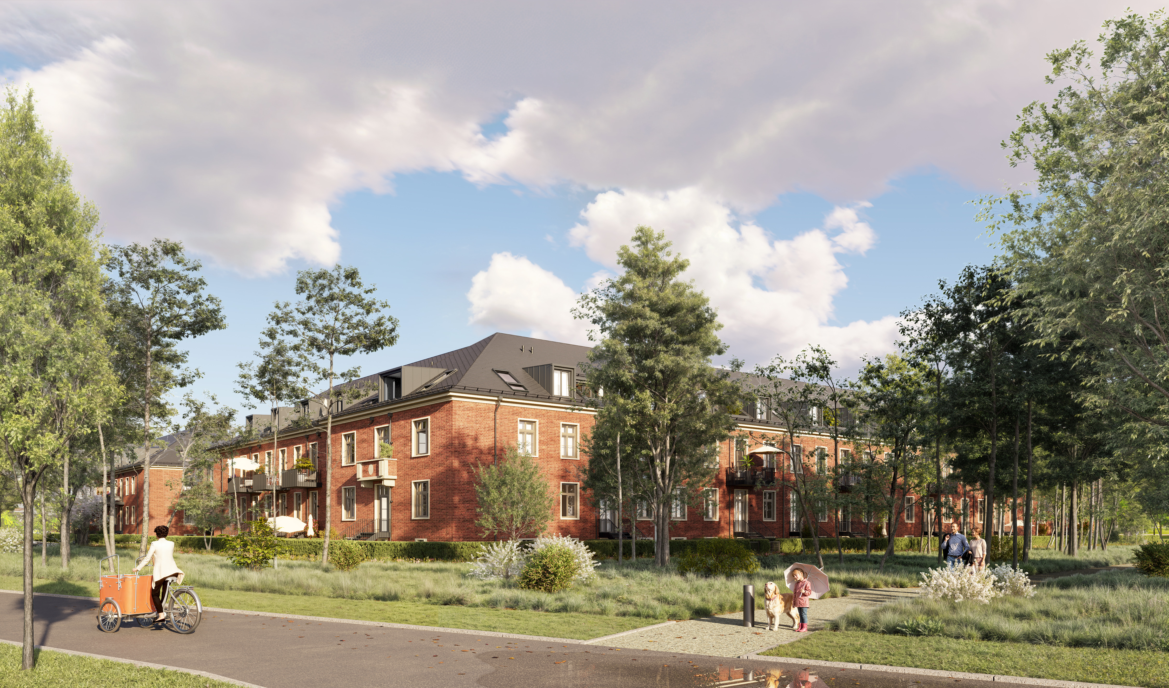 Zu sehen sind von der Straße aus, mehrere braune Häuser des Projekts BUWOG Lillestad. Außerdem ist ein Gehweg vom Projekt zur Straße aus zu sehen mit Personen. Auf der Straße befindet sich eine Radfahrerin.