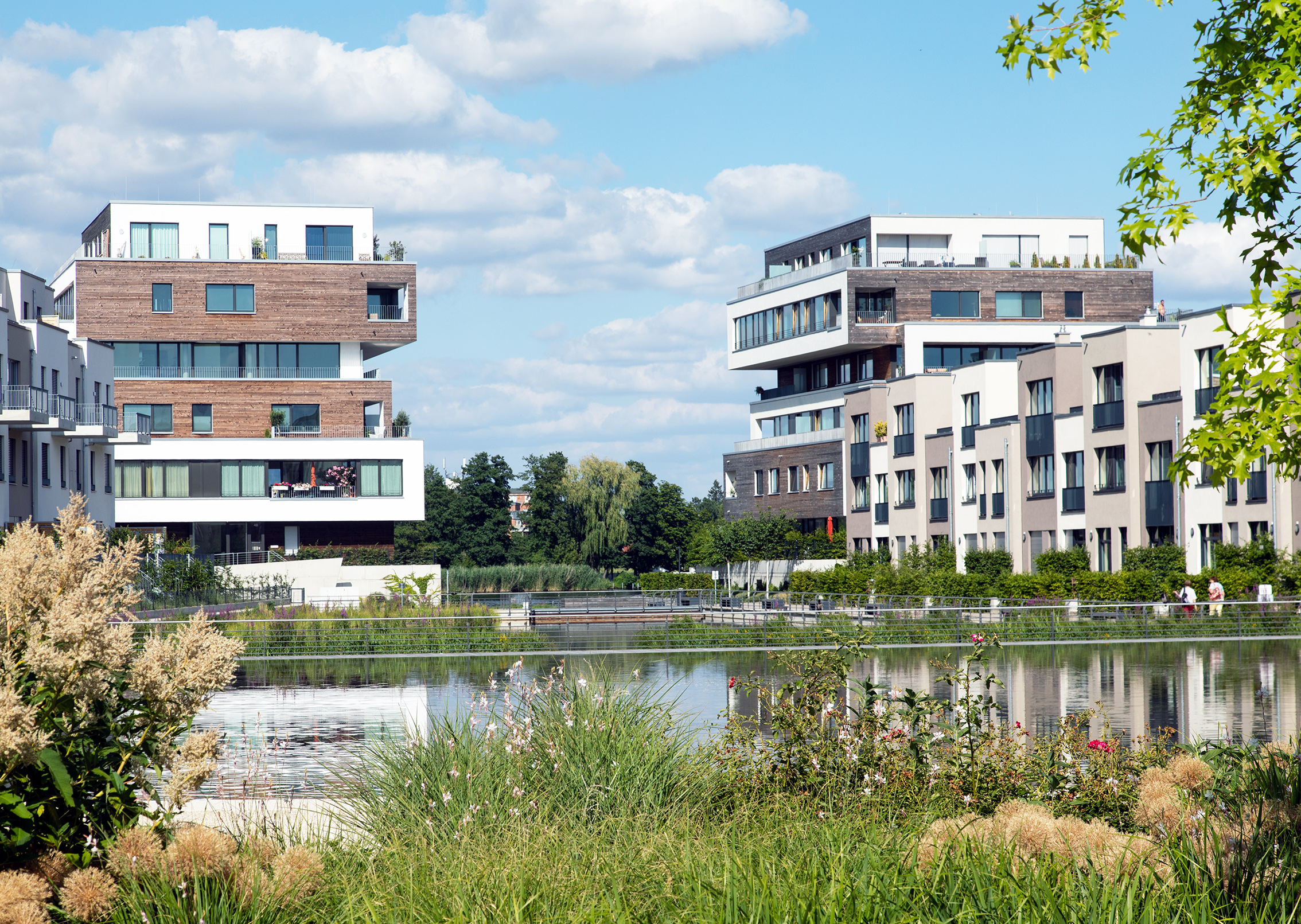 You can see several buildings in the distance, water and green spaces in the foreground.