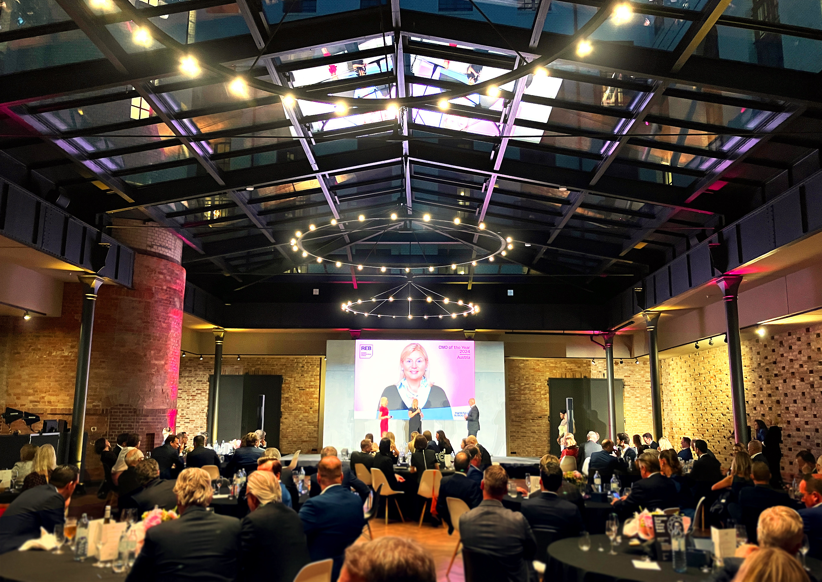 Festive presentation of the Real Estate Brand Award on a stage in the Berlin Telegraph Office